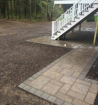 paved walkway leading to back deck